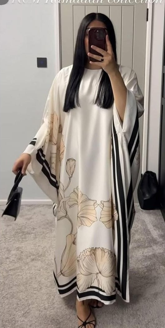 A Chic, Modern Kaftan Dress Featuring A Flowy, Loose Silhouette In White With Elegant Beige Floral Prints