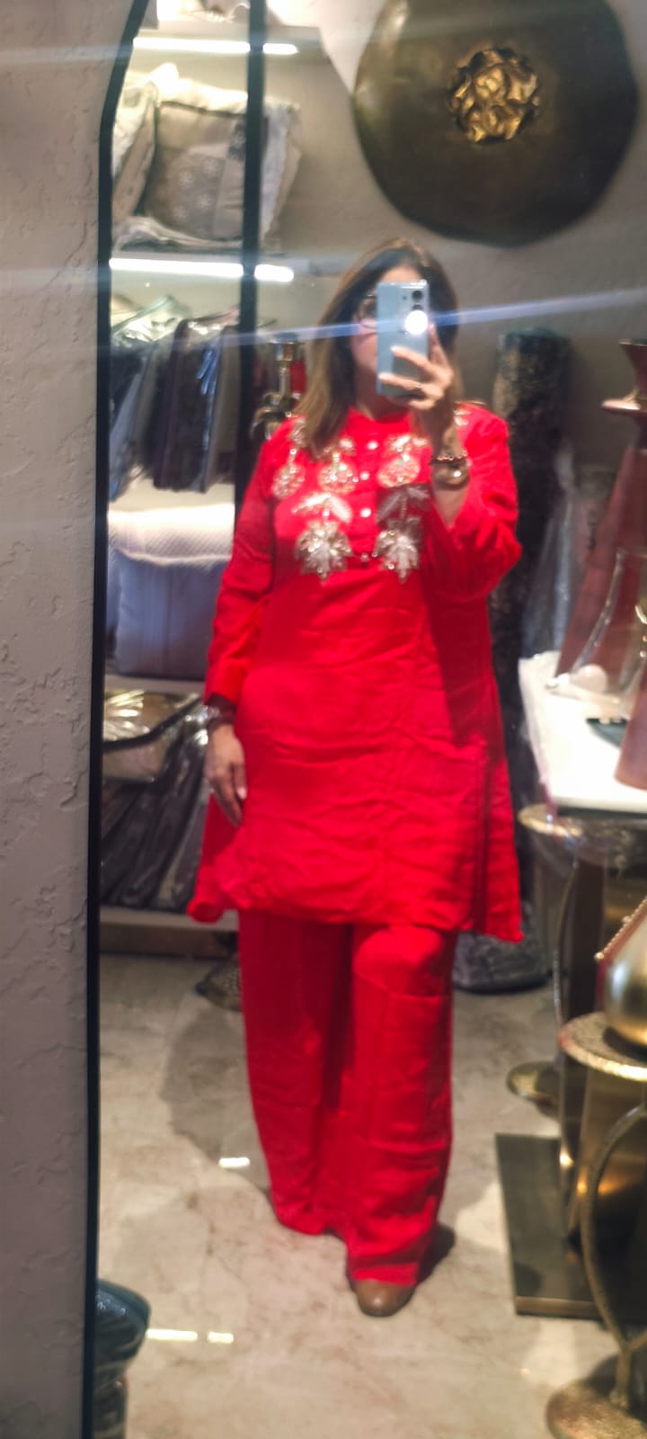 This Ensemble Showcases A Bold, Festive Look With A Vibrant Red Color