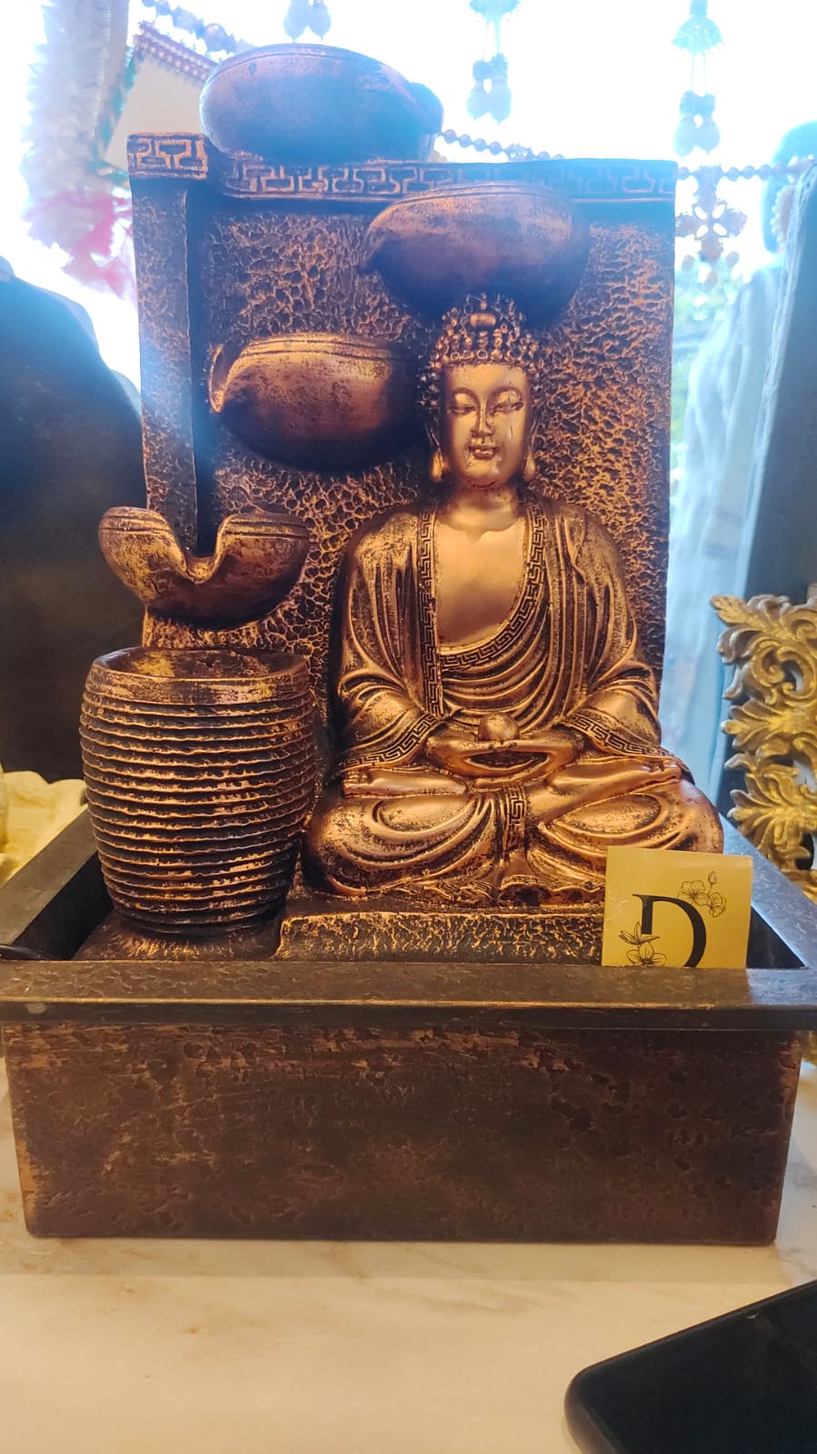 A Beautifully Designed Buddha Water Fountain Featuring A Meditating Buddha With Cascading Water Bowls