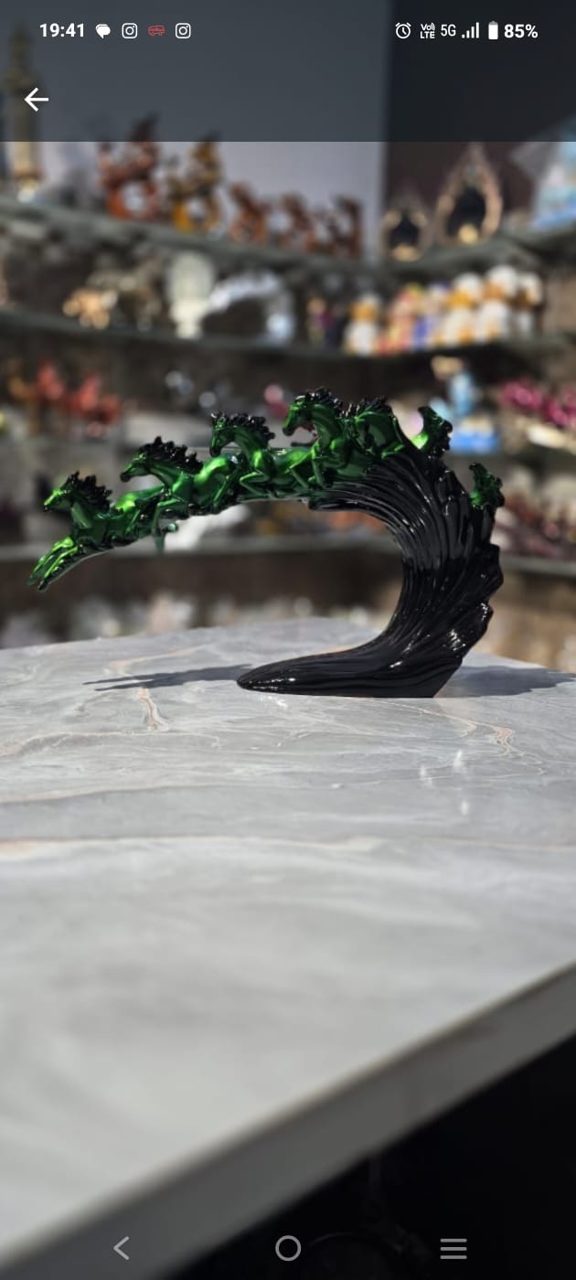 Dynamic and artistic sculpture of running horses, designed with a glossy green and black