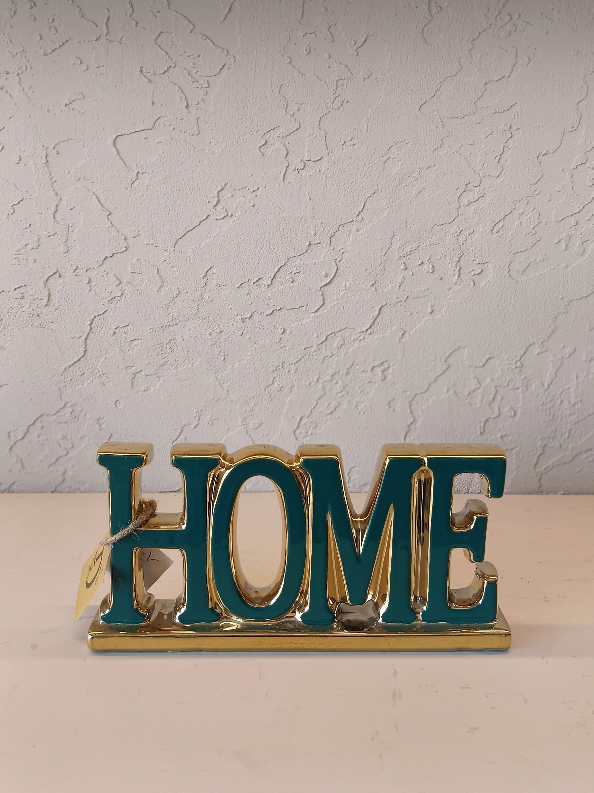 Stylized Home Lettering With A Polished Teal And Gold