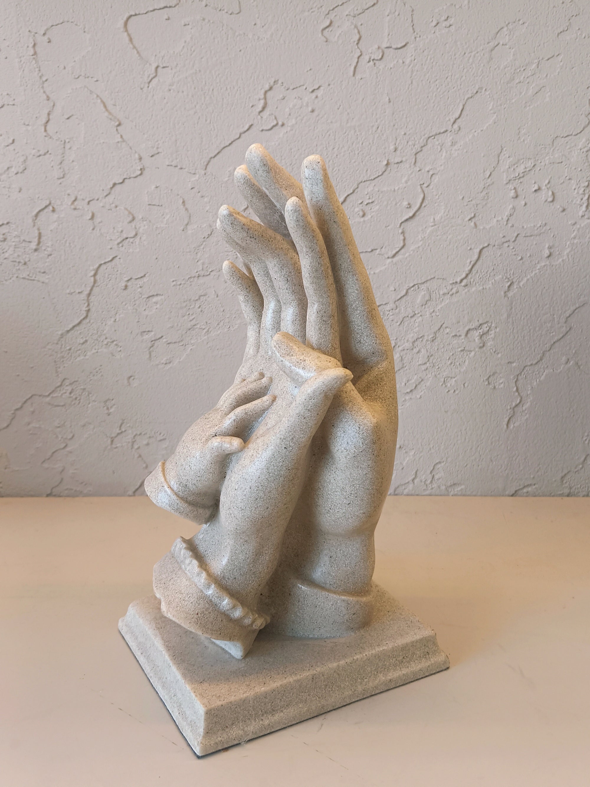 Sculpture With Child,s Hand Resting,Symbolizing love