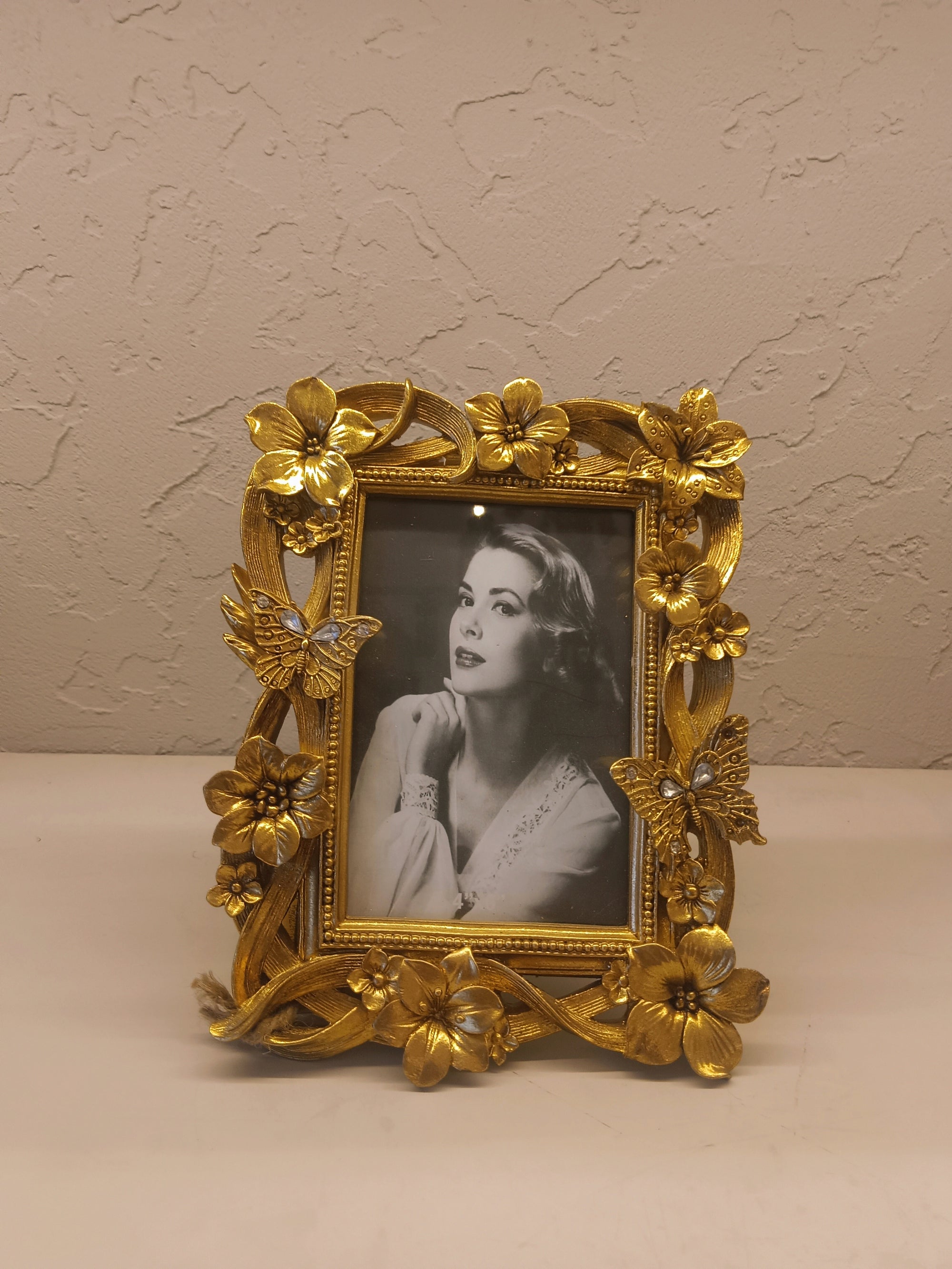 Ornate Golden Photo frame Adorned With Intricately Sculpted Flowers And Butterflies