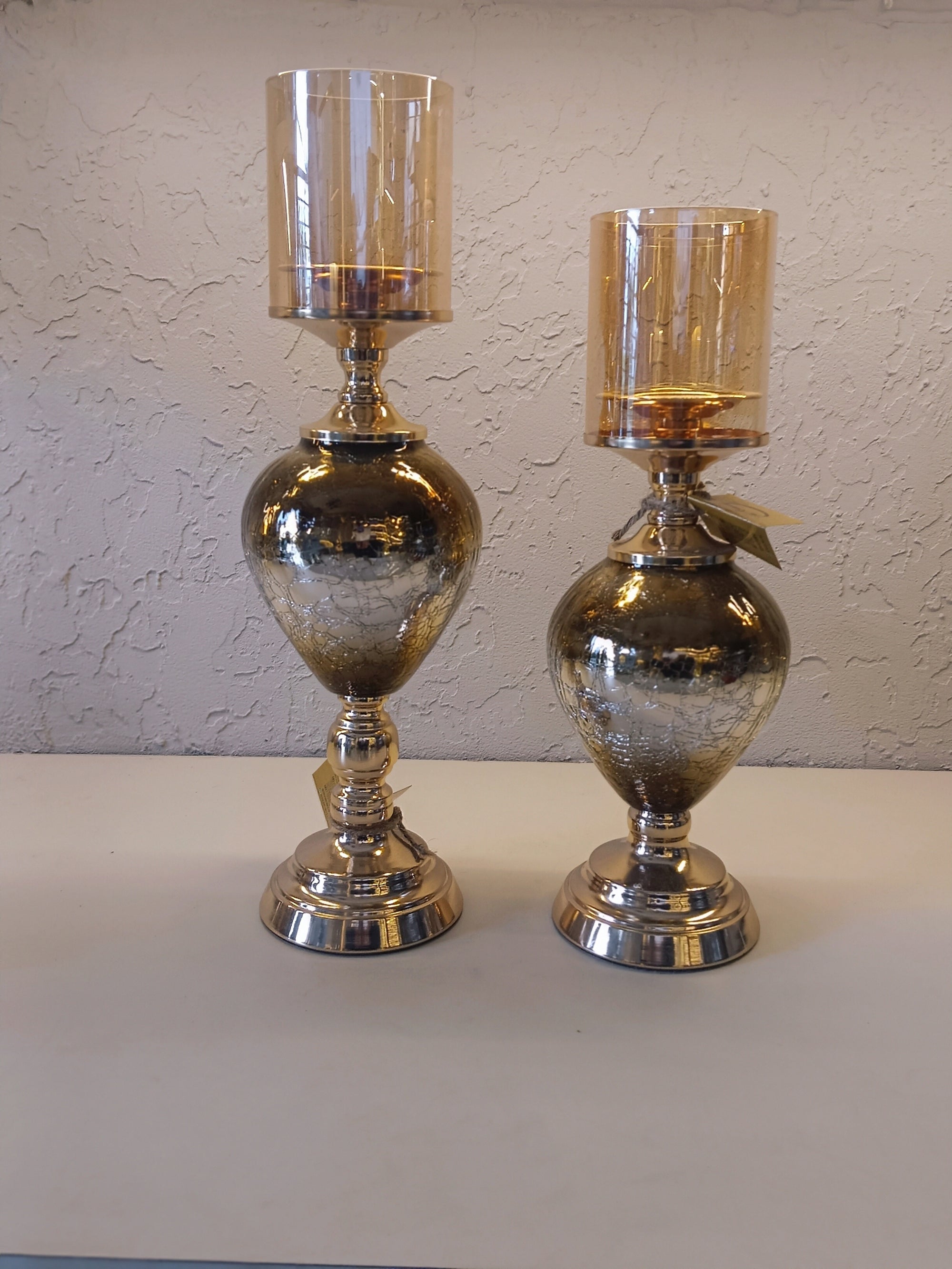 Candle Holders With A Reflective Silver Finish And Amber -Tinted Glass