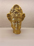 Crafted Golden Decorative Sculpture Of A Serene Face