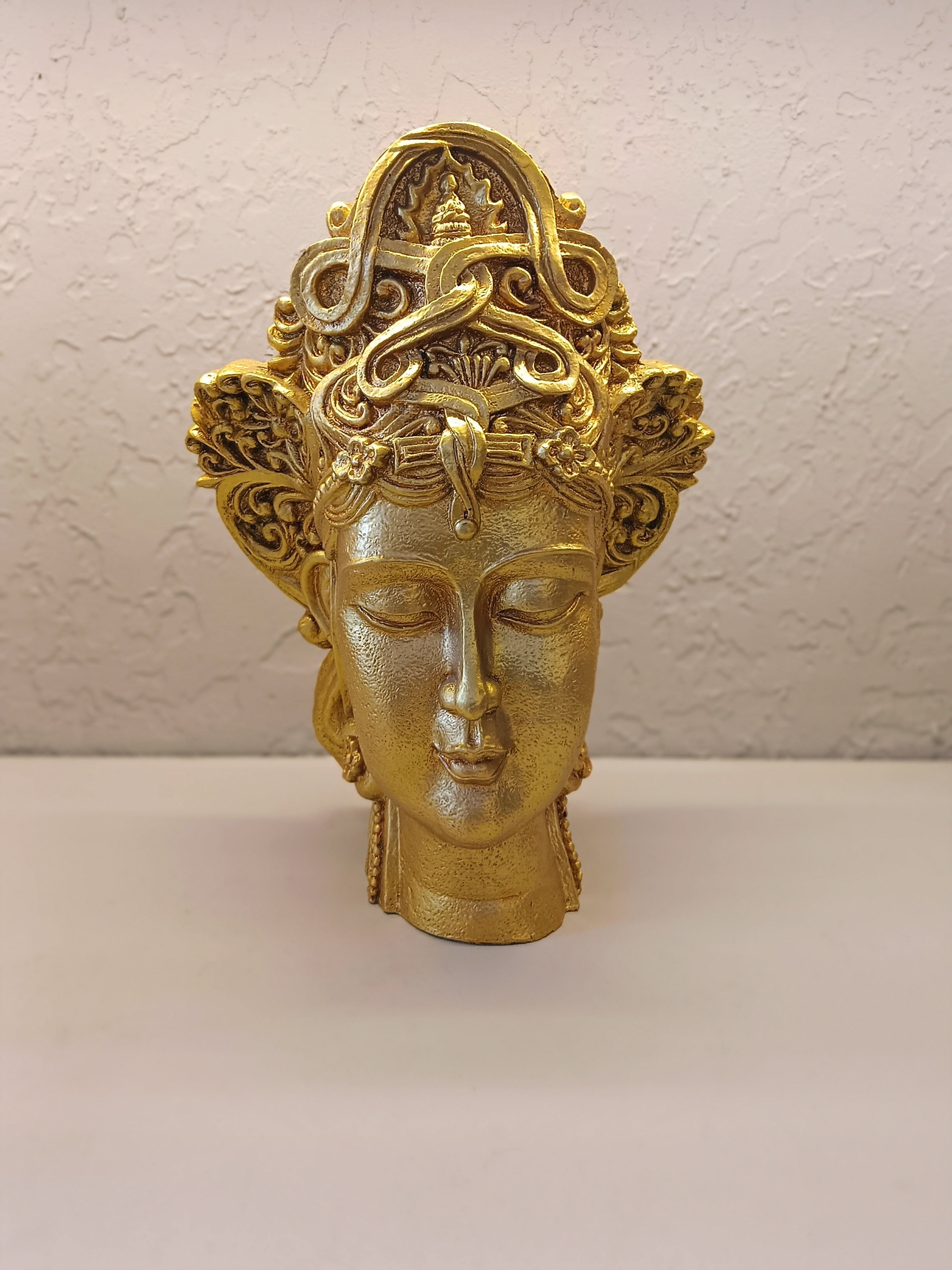 Crafted Golden Decorative Sculpture Of A Serene Face
