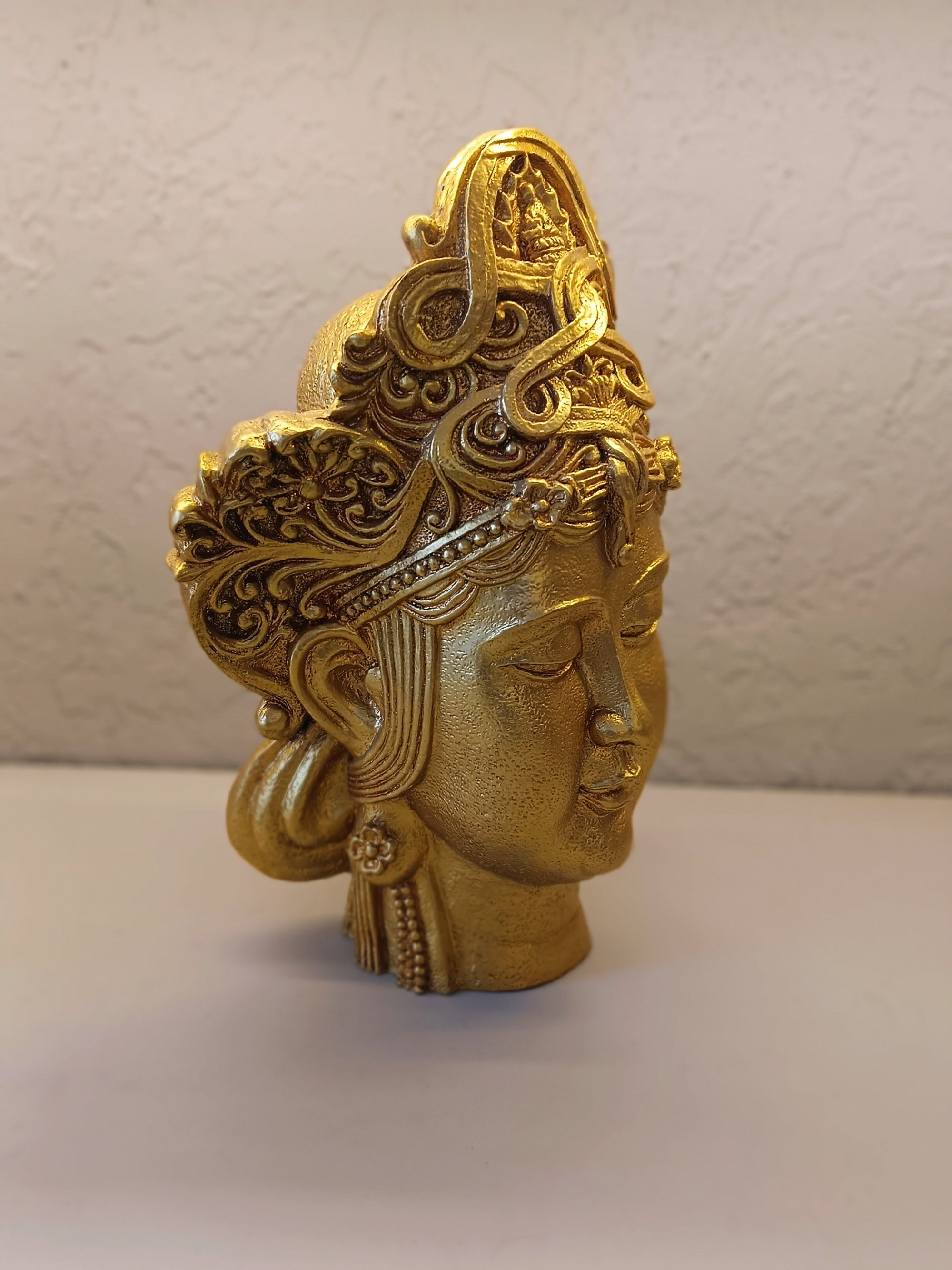 Crafted Golden Decorative Sculpture Of A Serene Face