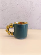 This Is A Stylish Ceramic Mug Featuring A Glossy Teal Body