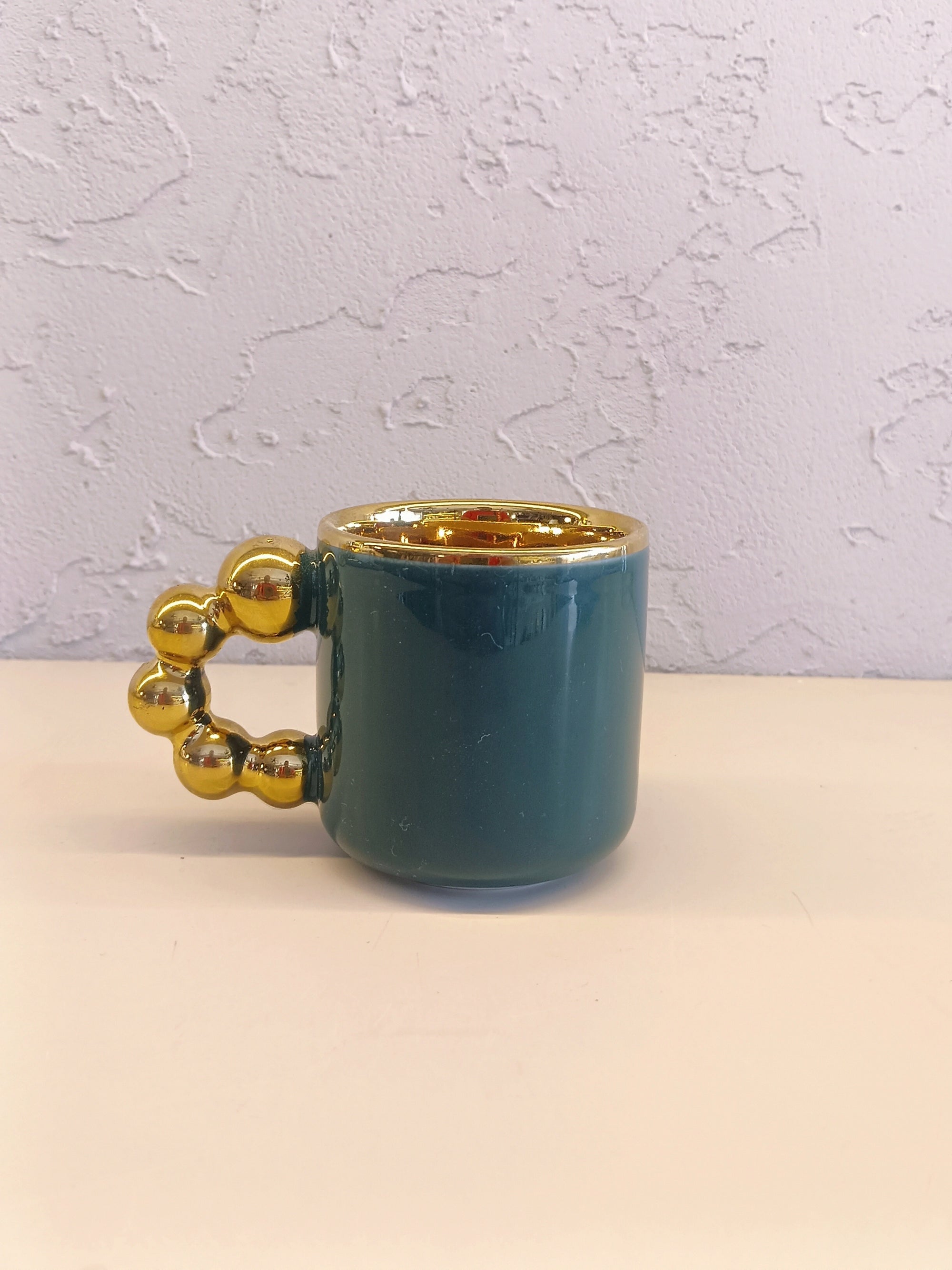 This Is A Stylish Ceramic Mug Featuring A Glossy Teal Body