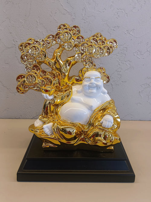 A Decorative Figurine Featuring A White And Gold Representation Of The Laughing Buddha