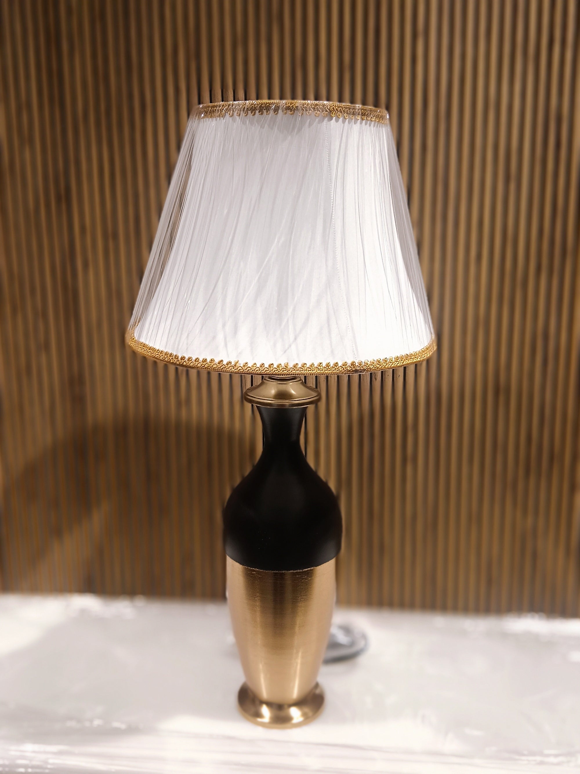 Stylish Modern Table Lamp With A Sleek Black And Gold Metallic Base