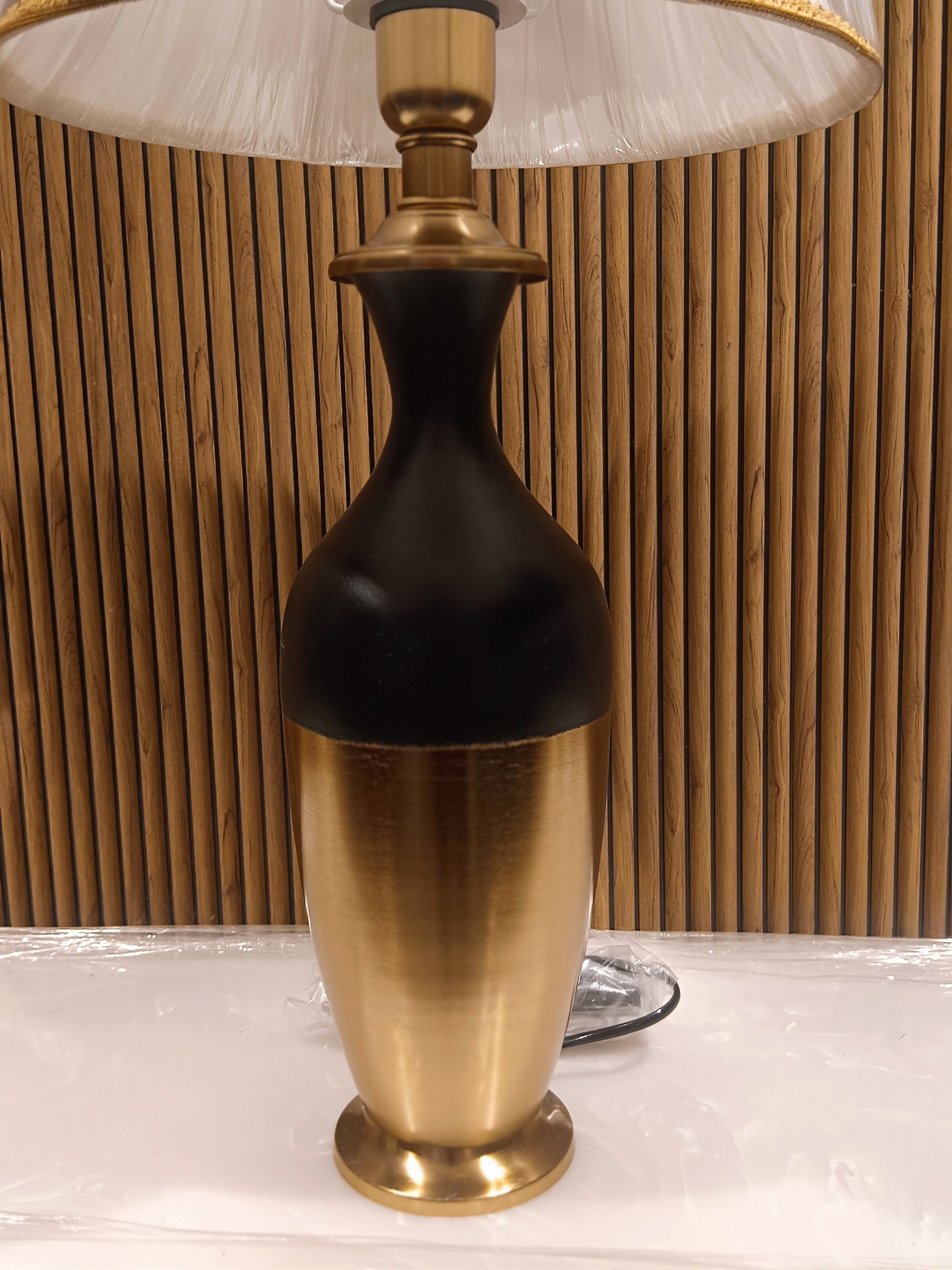 Stylish Modern Table Lamp With A Sleek Black And Gold Metallic Base