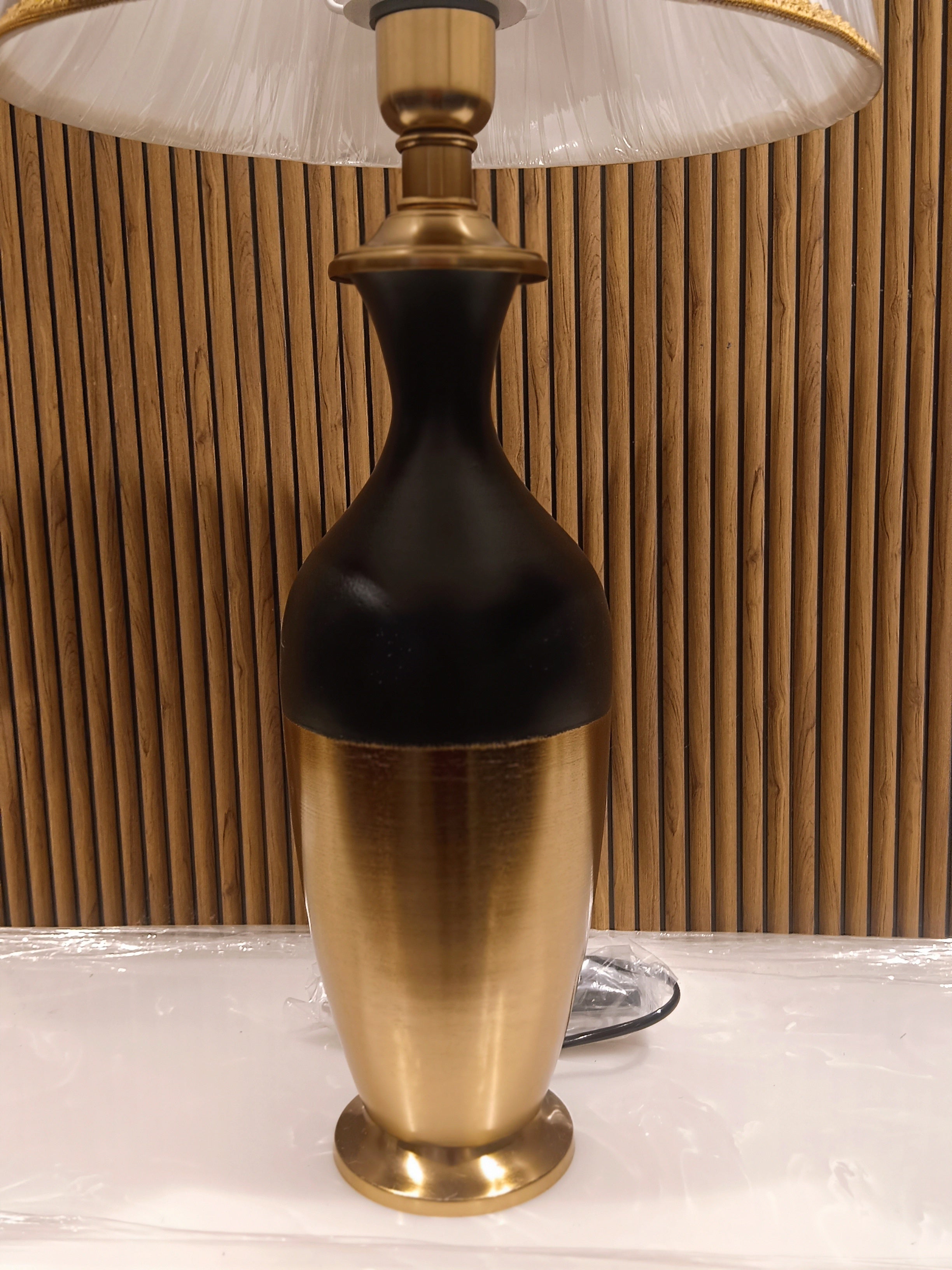 Stylish Modern Table Lamp With A Sleek Black And Gold Metallic Base