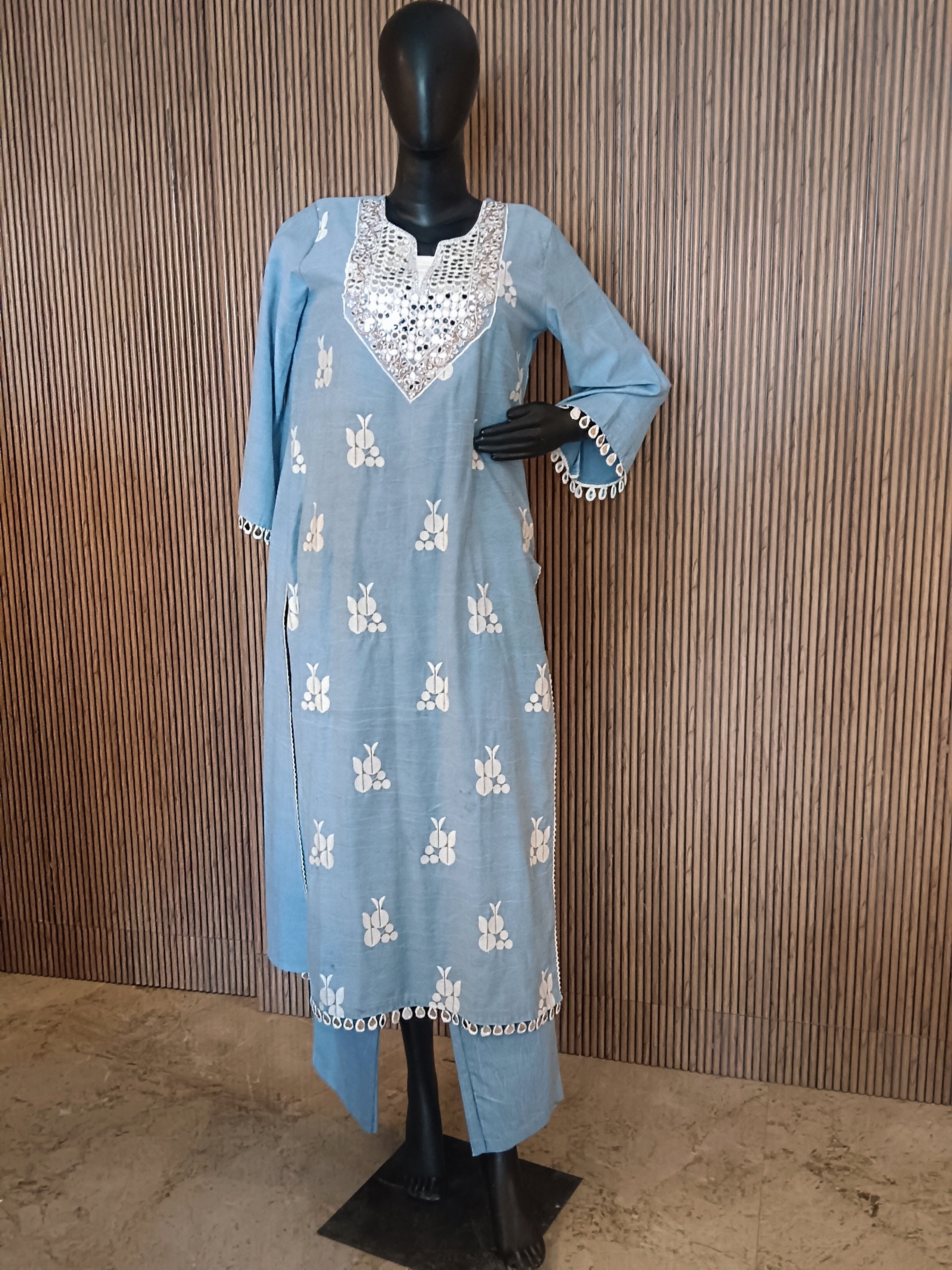 A Refreshing Sky Blue Kurti Set Adorned With Delicate White Motifs And Striking Mirror-Work