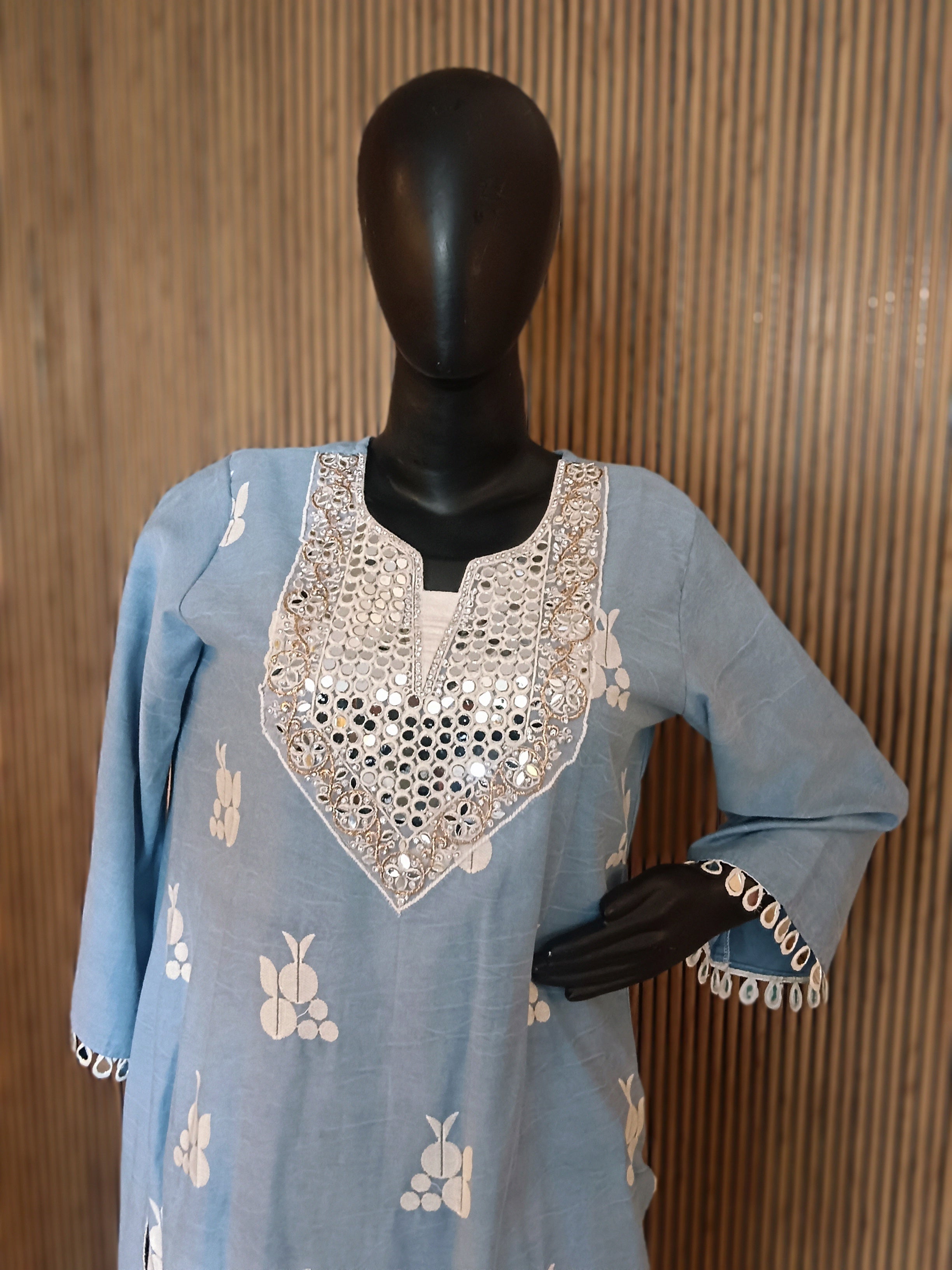 A Refreshing Sky Blue Kurti Set Adorned With Delicate White Motifs And Striking Mirror-Work