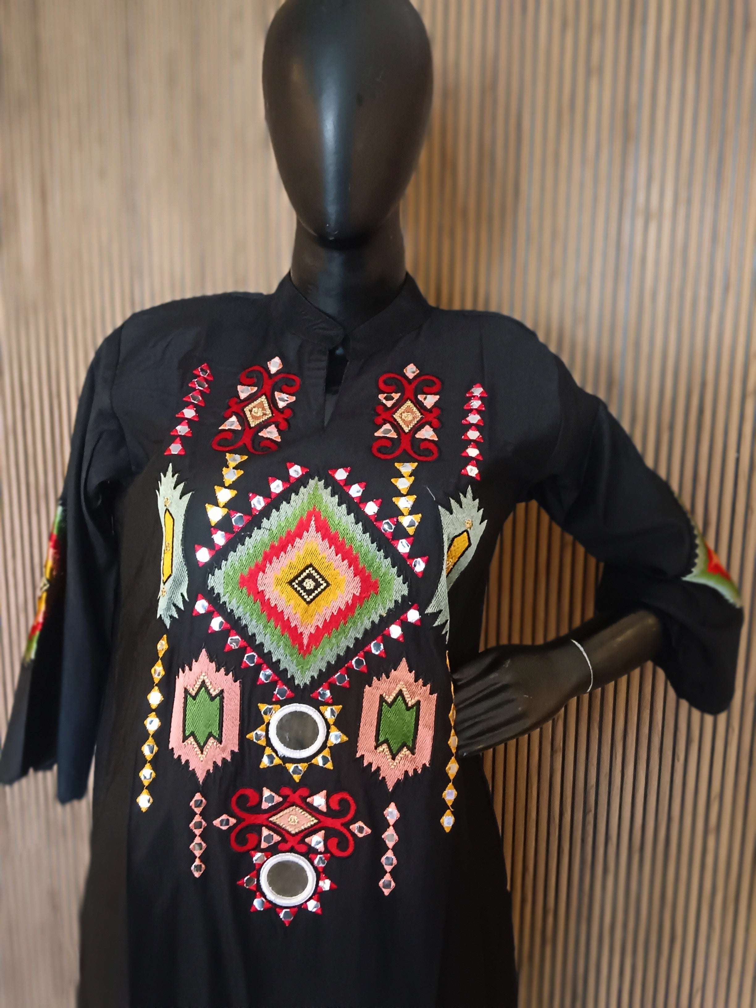 Black Kurti With Bold, Multicolored Geometric Embroidery And Mirror Work On The Yoke And Sleeves,