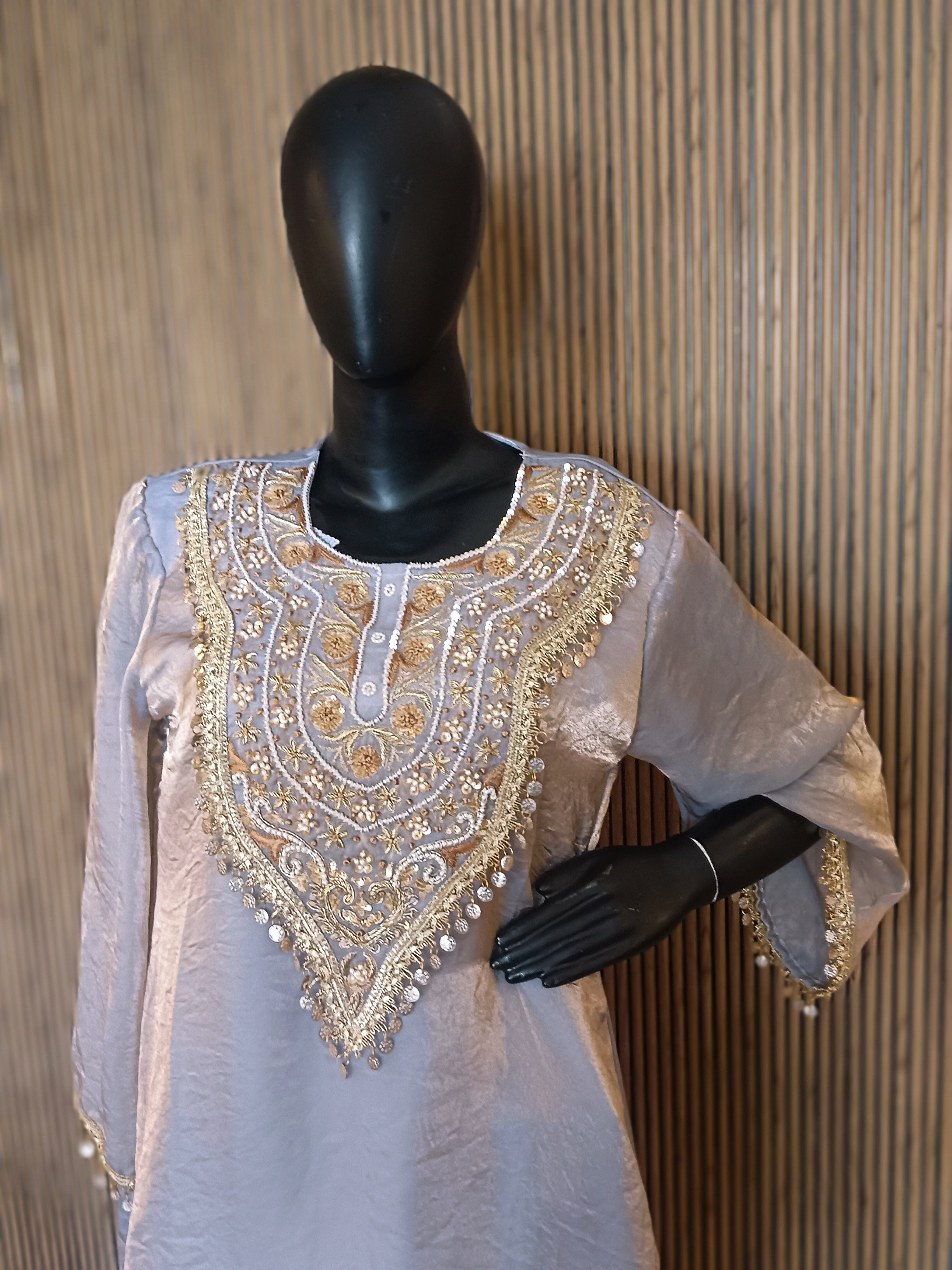 This Elegant Ensemble Features A Shimmering Light Gray Kurti With Luxurious Gold And Silver Embroidery At The Neckline, Sleeves