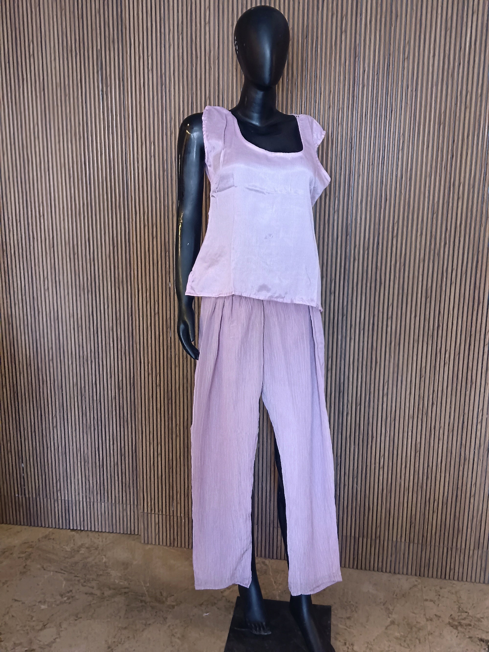An Elegant Pastel Lavender Kurti Featuring Rich Gold And Mirror Embroidery On The Yoke, Accented With Sequins And Beads