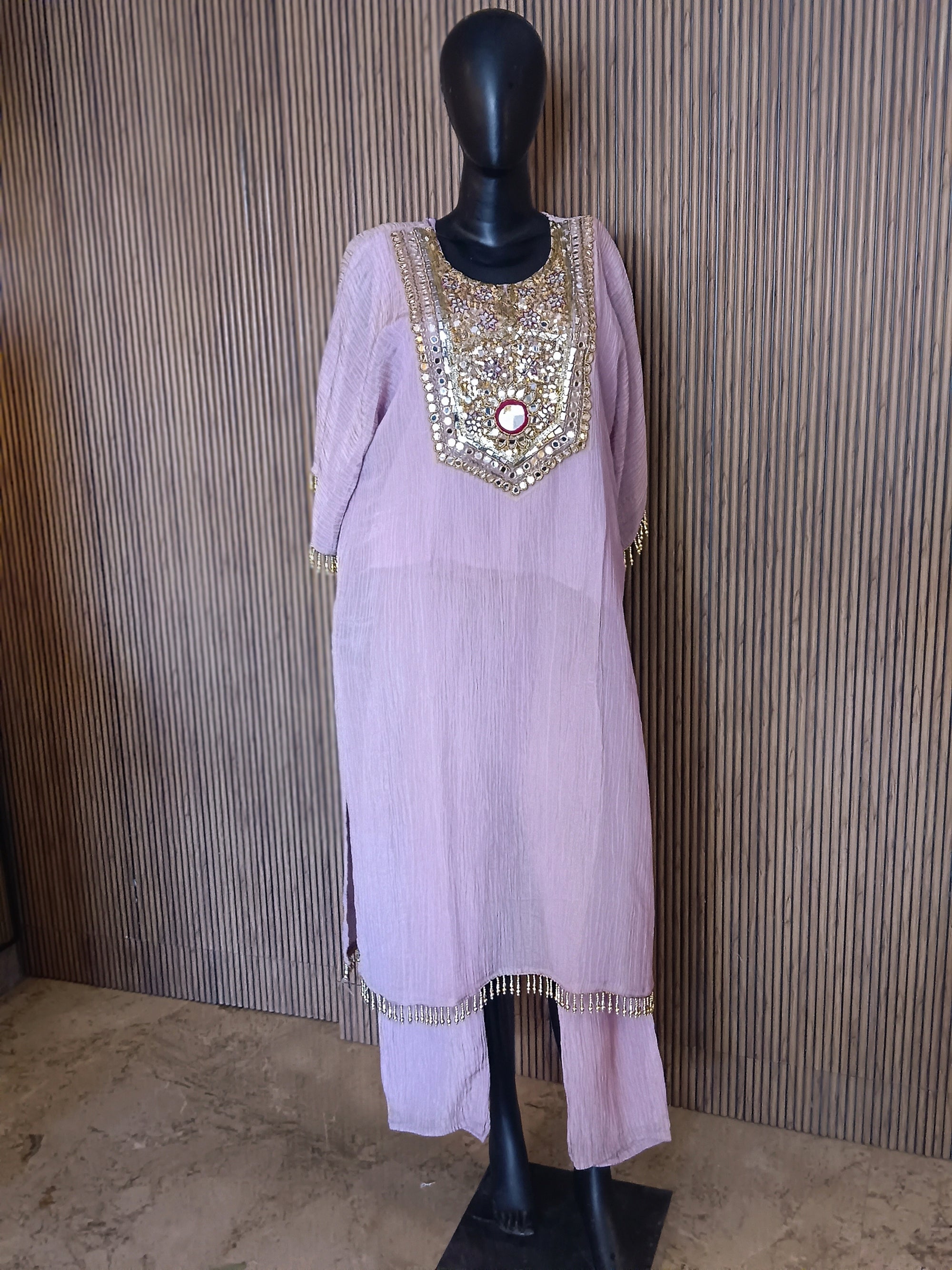 An Elegant Pastel Lavender Kurti Featuring Rich Gold And Mirror Embroidery On The Yoke, Accented With Sequins And Beads
