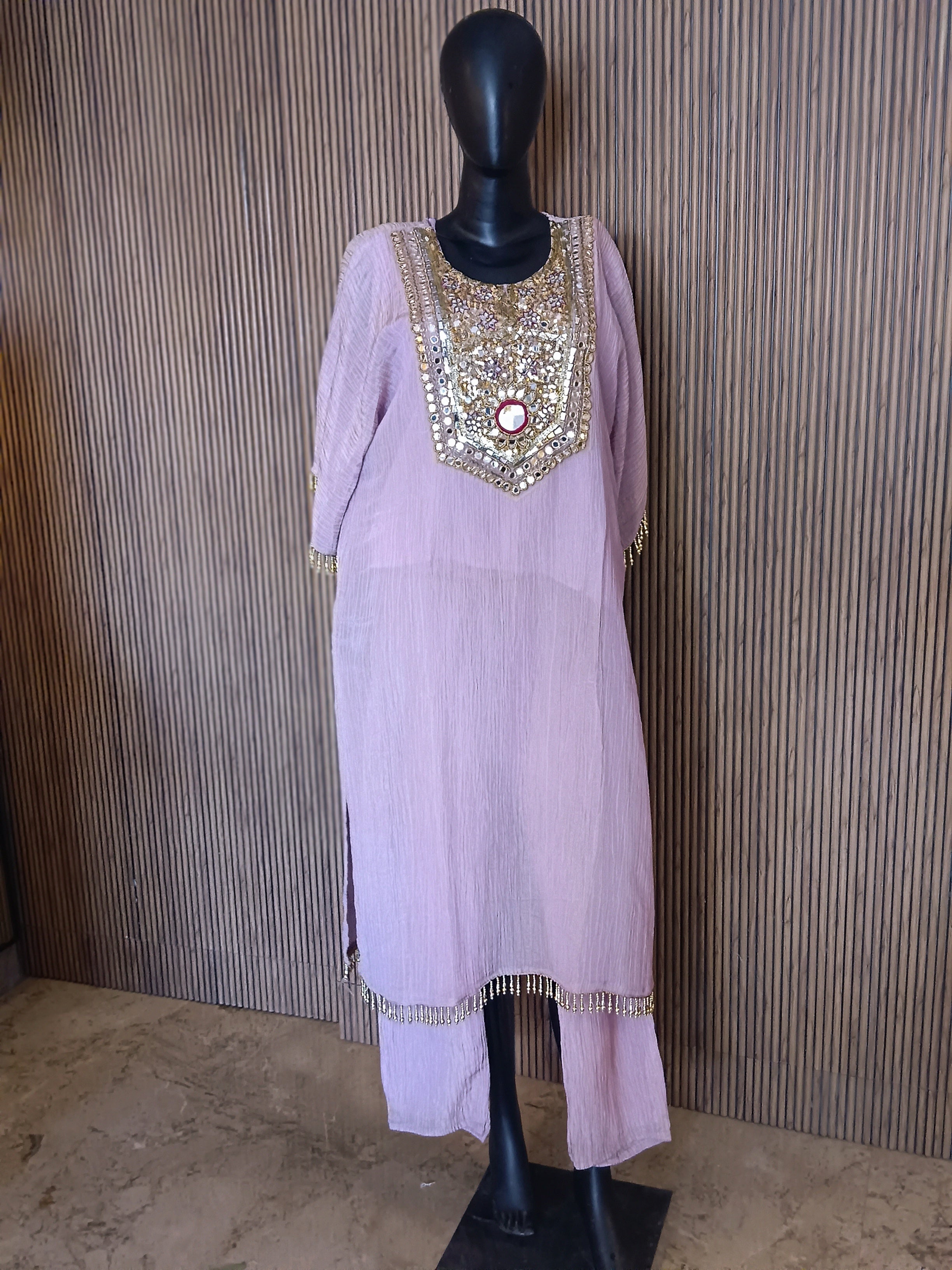 An Elegant Pastel Lavender Kurti Featuring Rich Gold And Mirror Embroidery On The Yoke, Accented With Sequins And Beads