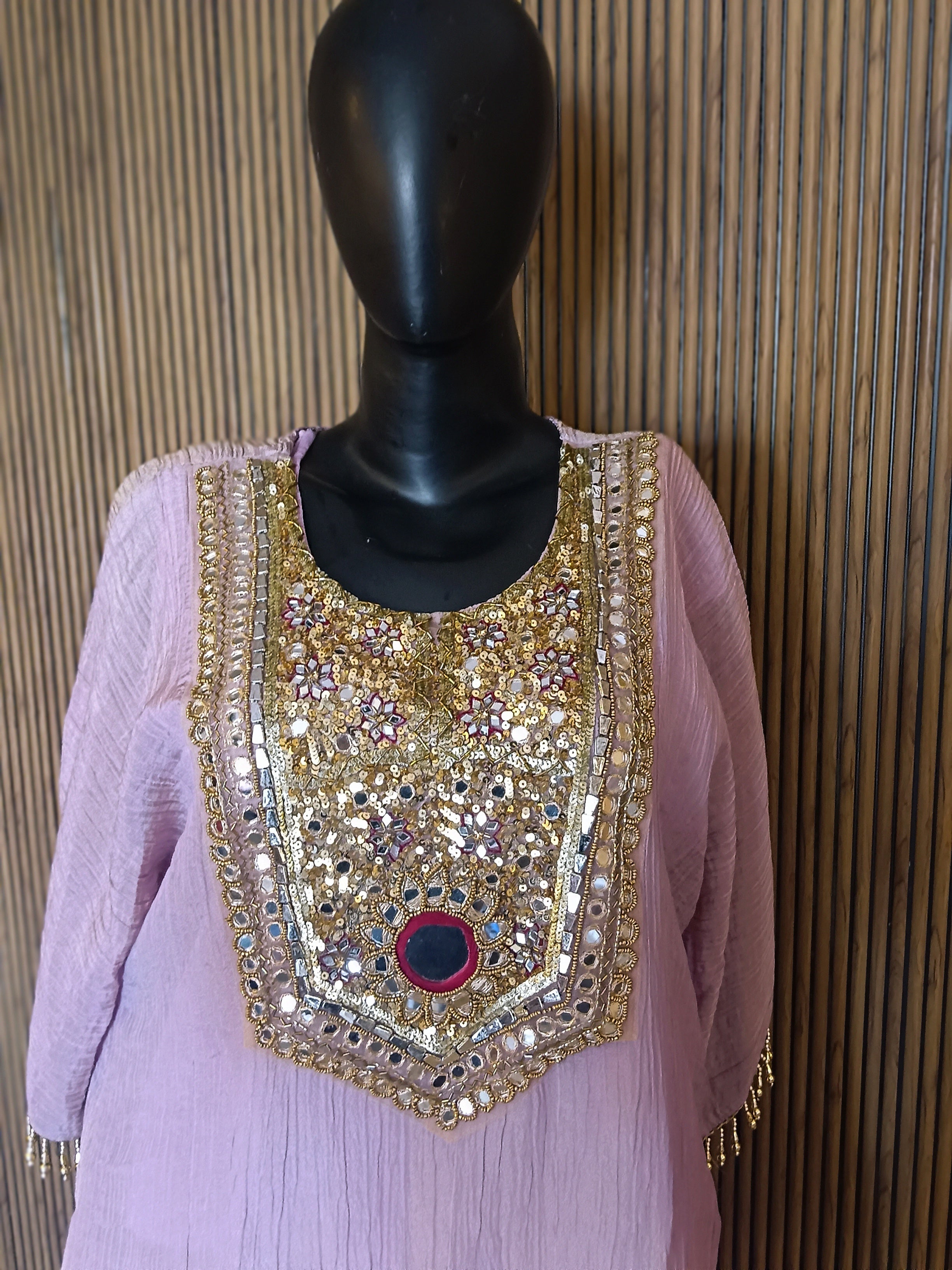 An Elegant Pastel Lavender Kurti Featuring Rich Gold And Mirror Embroidery On The Yoke, Accented With Sequins And Beads