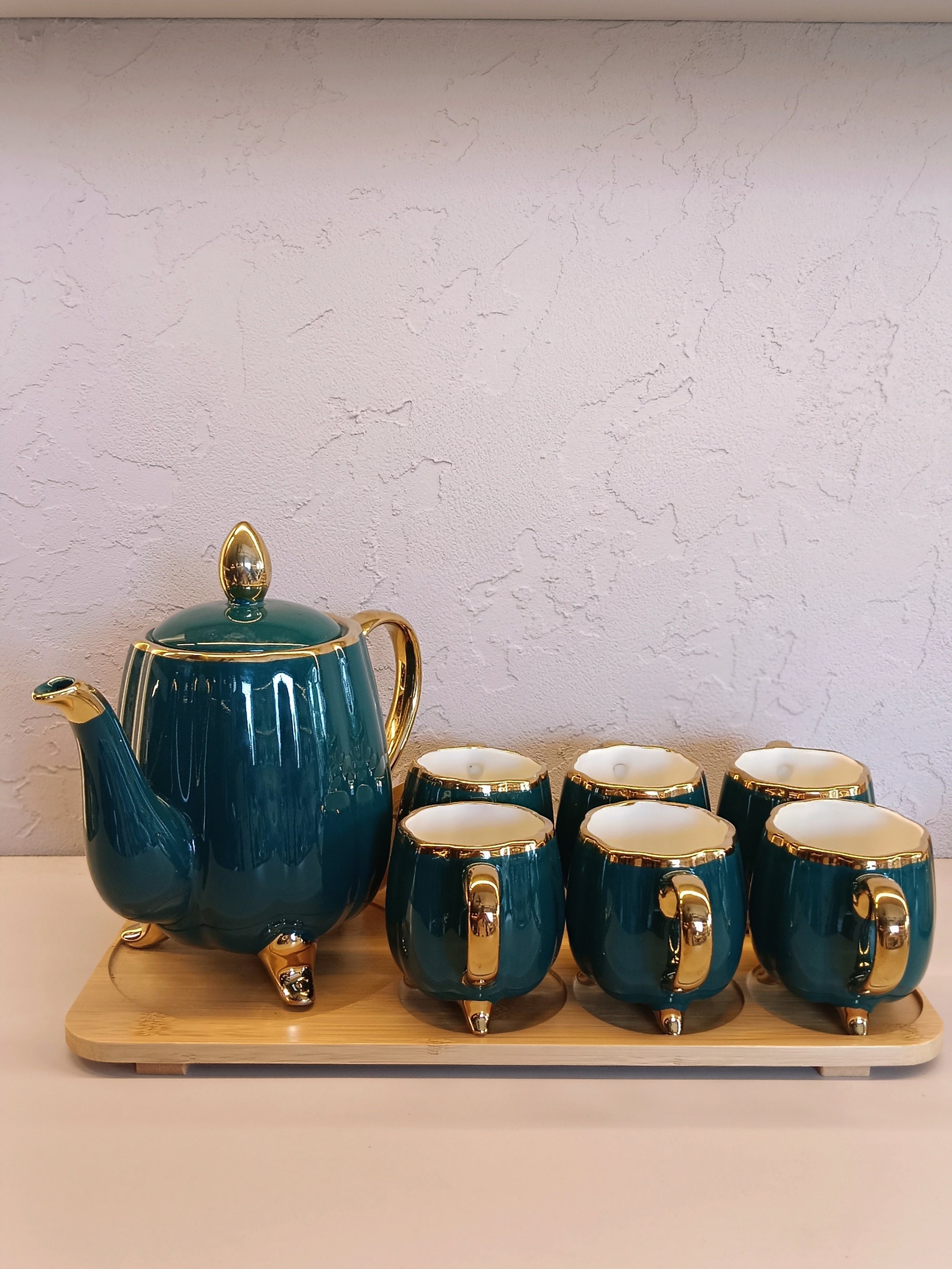 Elegant Ceramic Tea Set With A Glossy Green Finish And Gold Accents