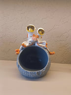 Decorative Figurine Featuring Two Astronauts In White Suits With Golden Visors