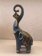 A Pair Of Intricately Crafted Decorative Elephant Figurines With Trunks Raised High, Symbolizing Prosperity