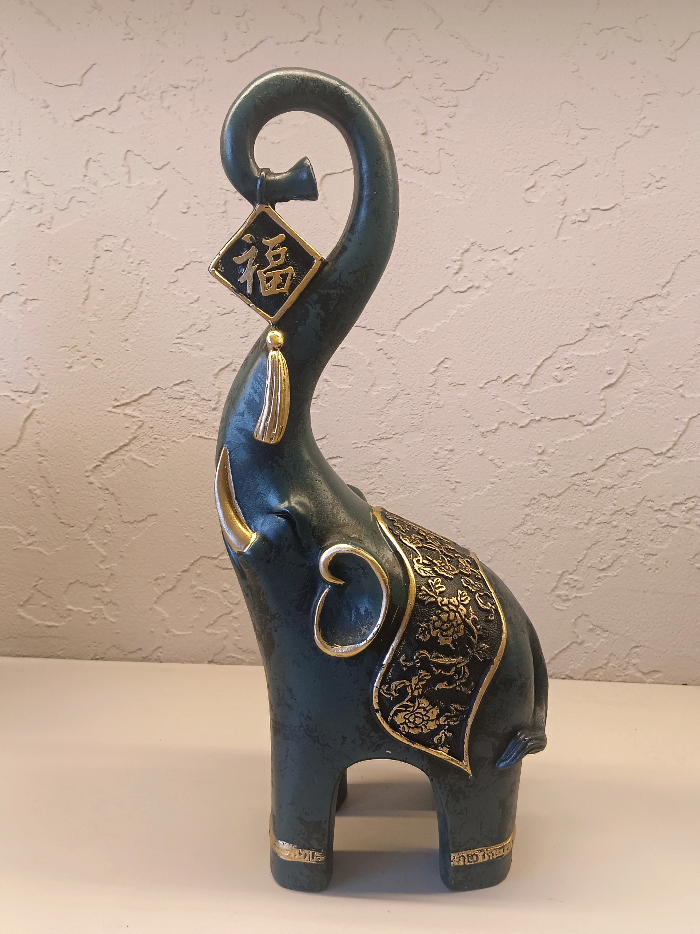A Pair Of Intricately Crafted Decorative Elephant Figurines With Trunks Raised High, Symbolizing Prosperity
