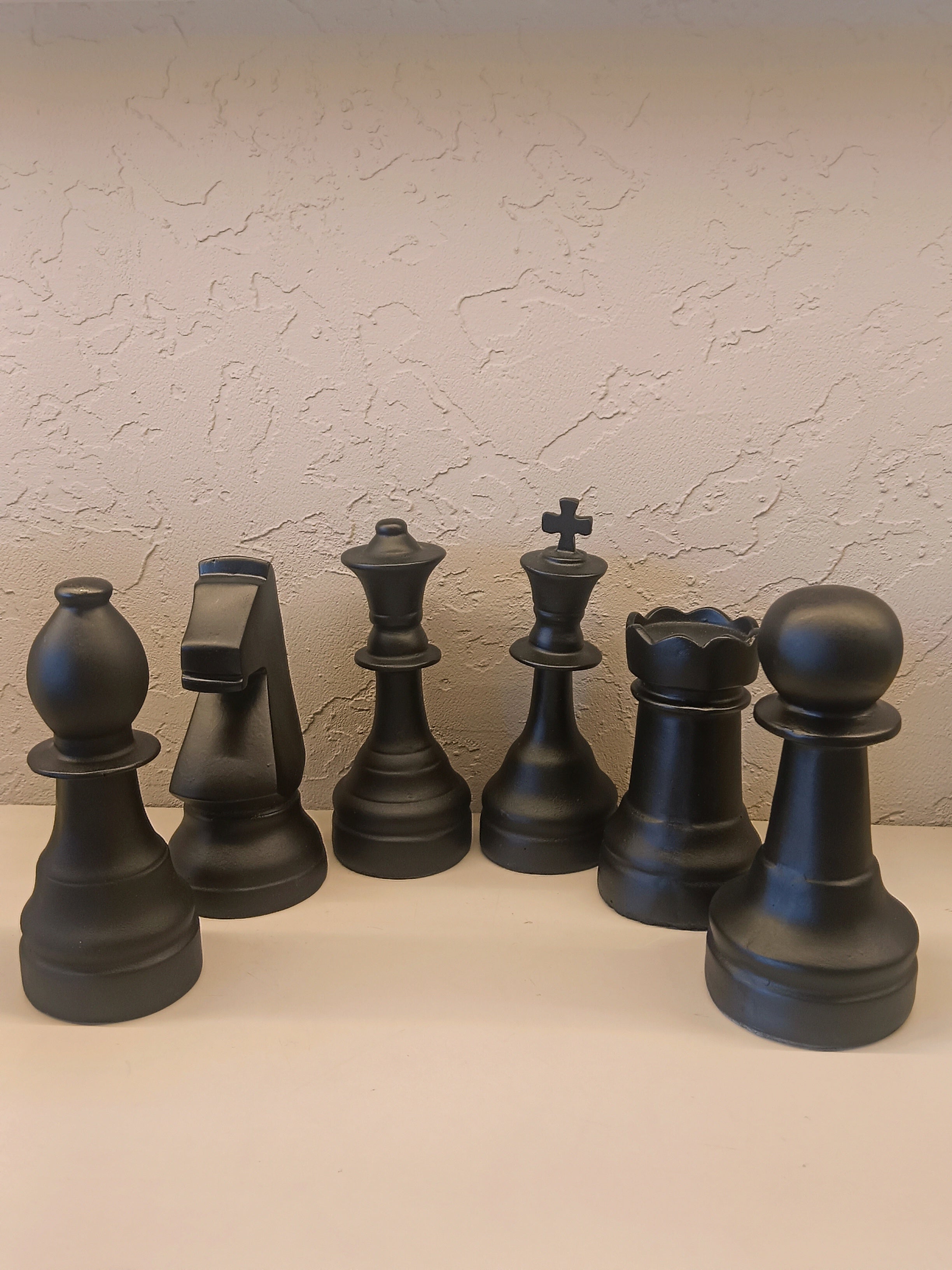 A Stylish Set Of Oversized Decorative Chess Pieces In A Sleek Matte Black Finish
