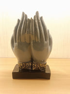This Elegant Buddha Head Statue Is Designed Within Protective Hands, Symbolizing Peace, Divine Blessings