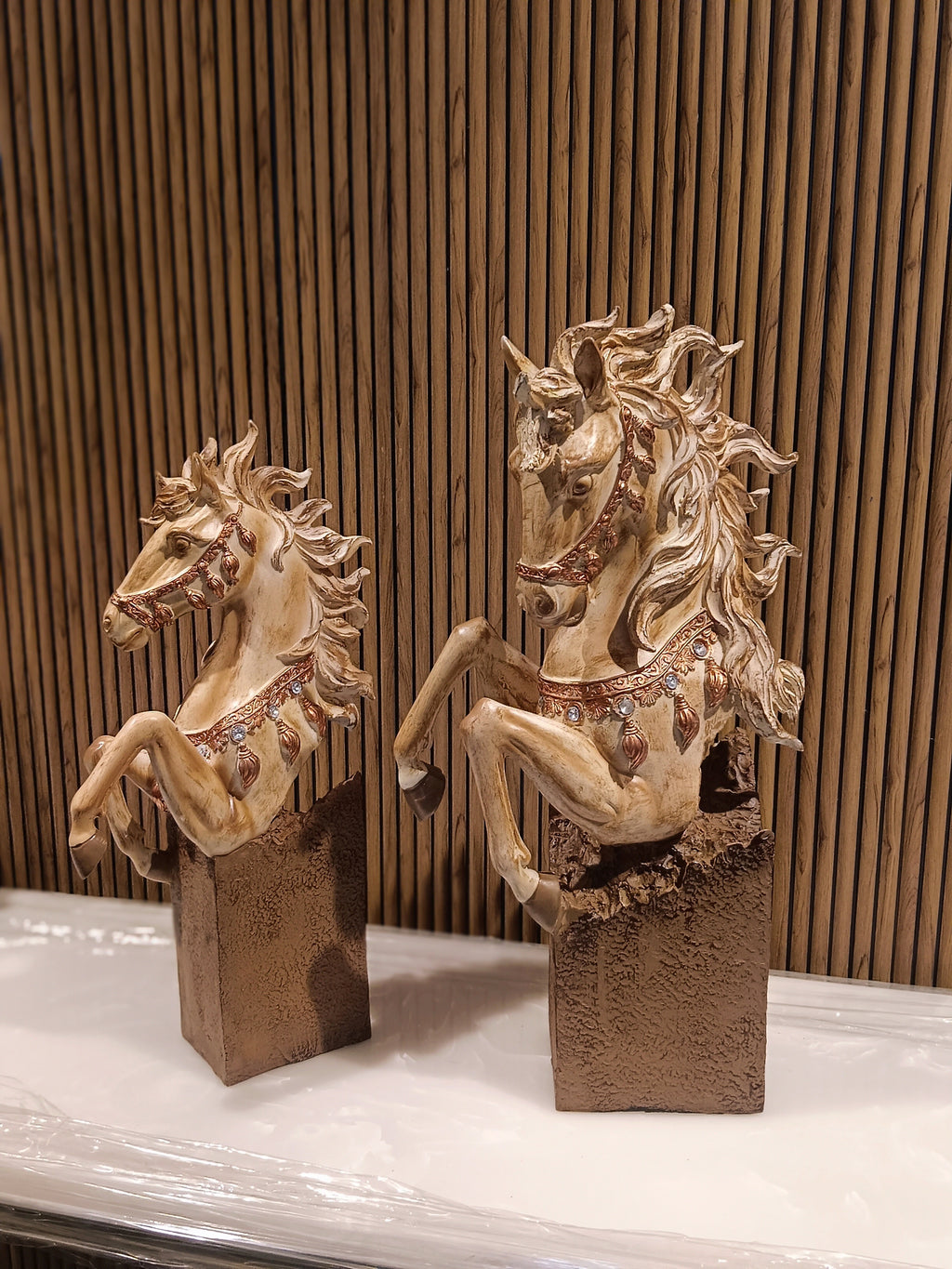 Set of two decorative rearing horse figurines, finely detailed with golden manes.