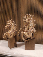 Set of two decorative rearing horse figurines, finely detailed with golden manes.
