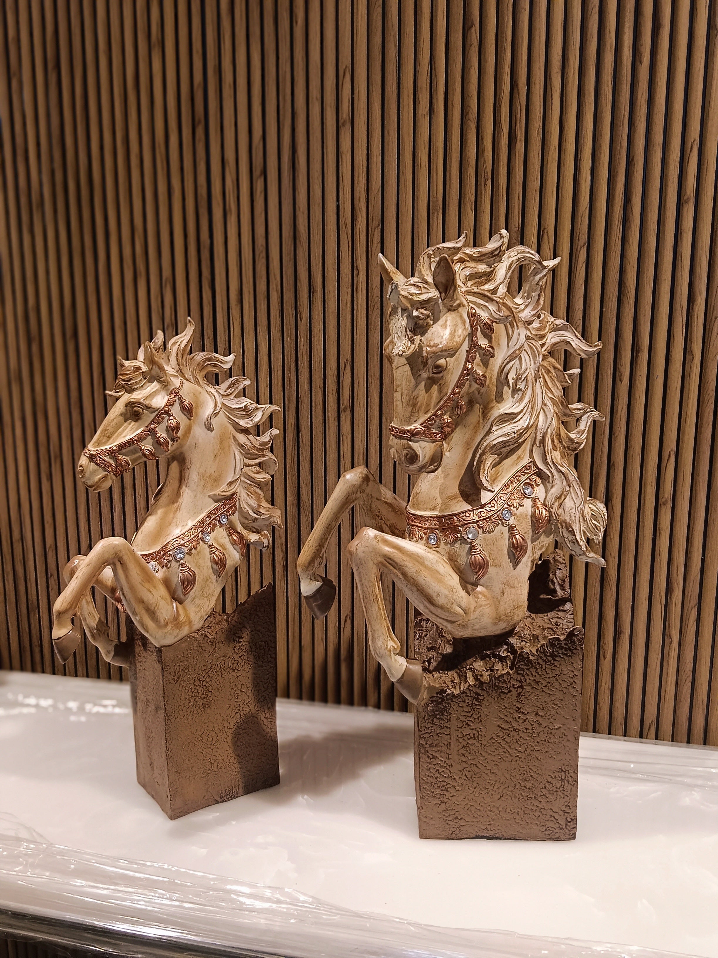 Set of two decorative rearing horse figurines, finely detailed with golden manes.