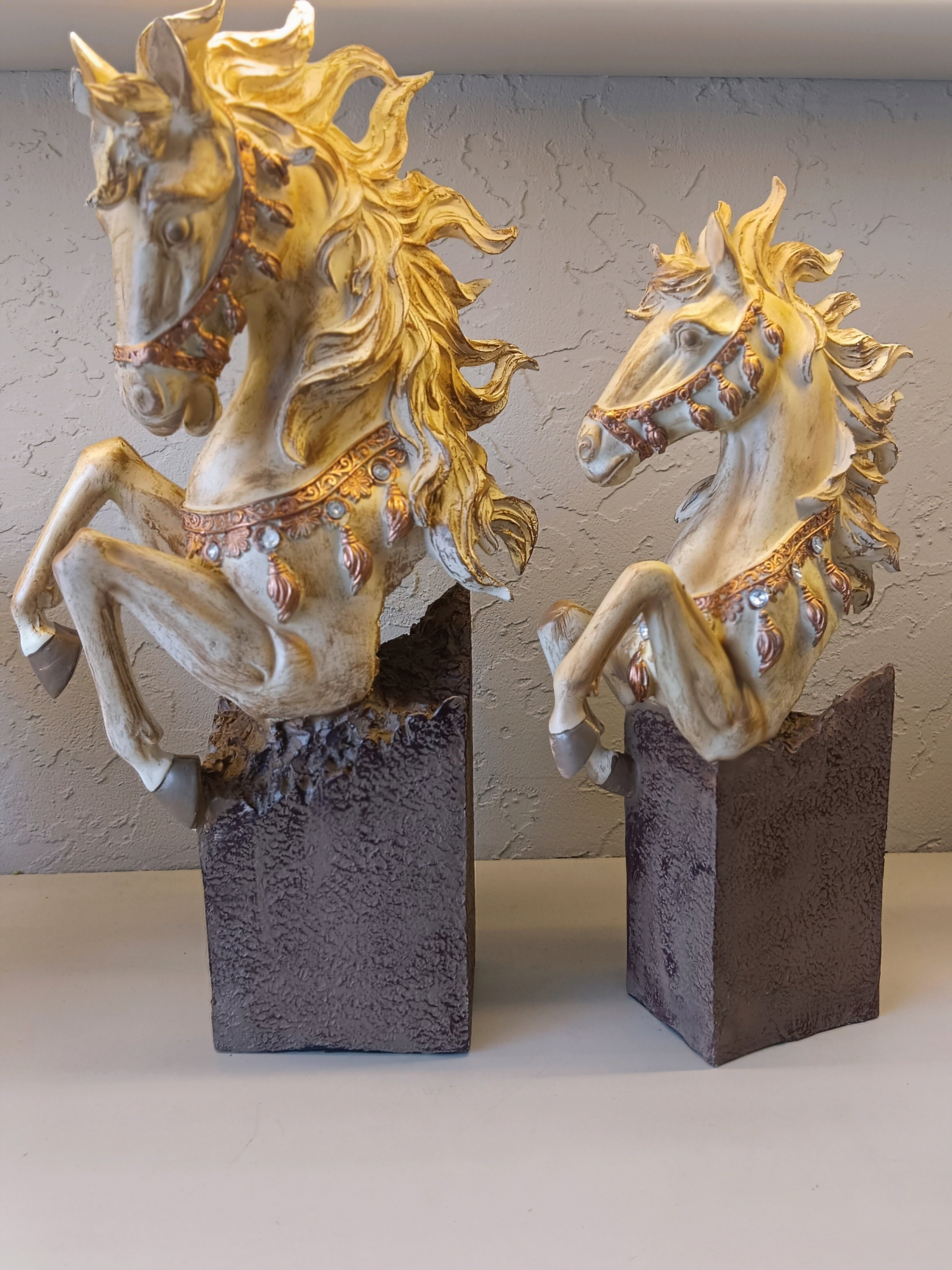 Set of two decorative rearing horse figurines, finely detailed with golden manes.