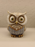 Elegant decorative owl figurines crafted with intricate detailing and a combination