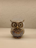 Elegant decorative owl figurines crafted with intricate detailing and a combination