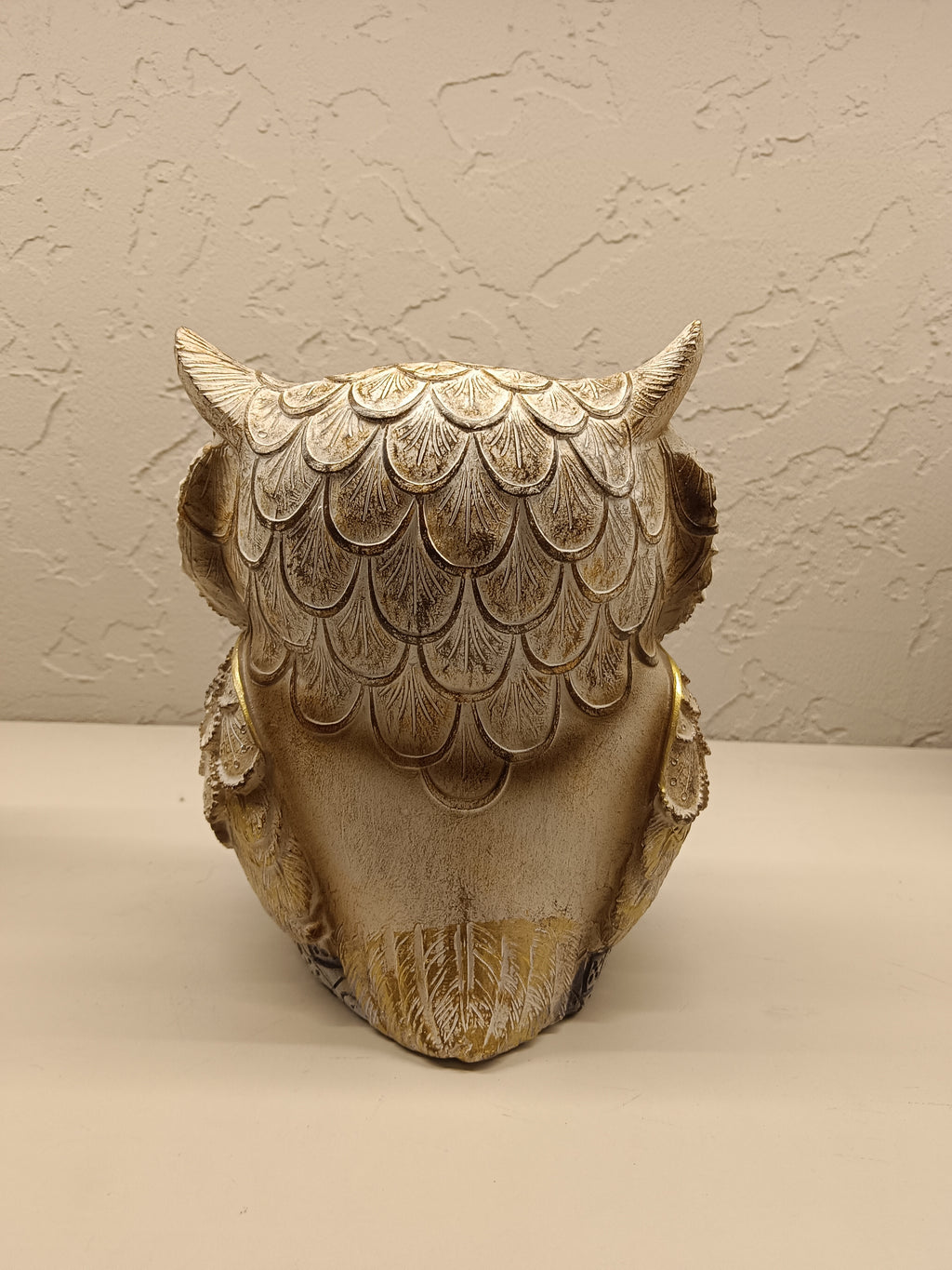 Elegant decorative owl figurines crafted with intricate detailing and a combination