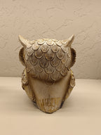 Elegant decorative owl figurines crafted with intricate detailing and a combination