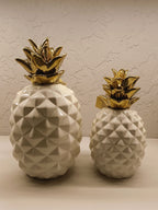 Stylish ceramic pineapple décor pieces with a modern geometric design and glossy finish.