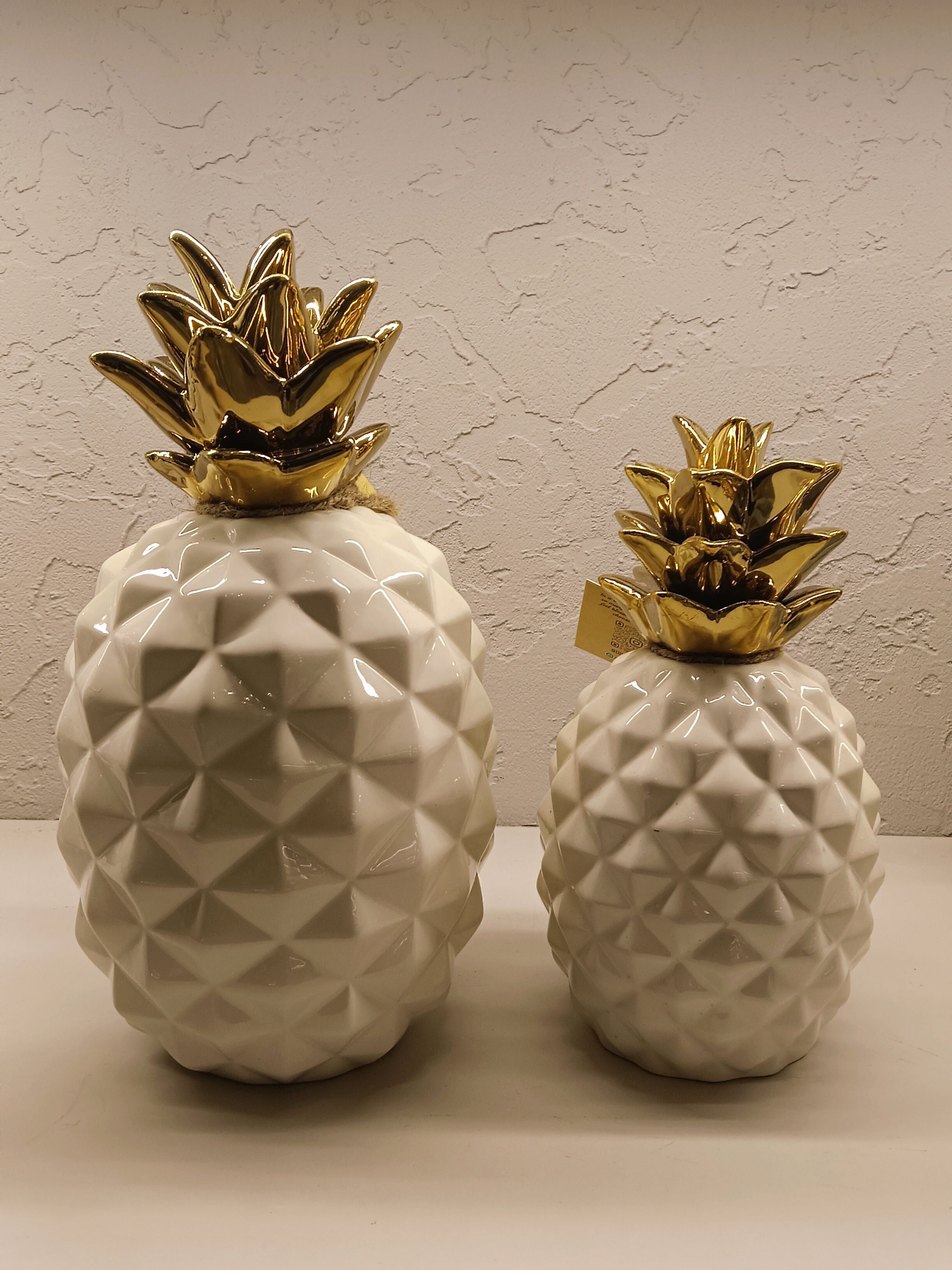 Stylish ceramic pineapple décor pieces with a modern geometric design and glossy finish.