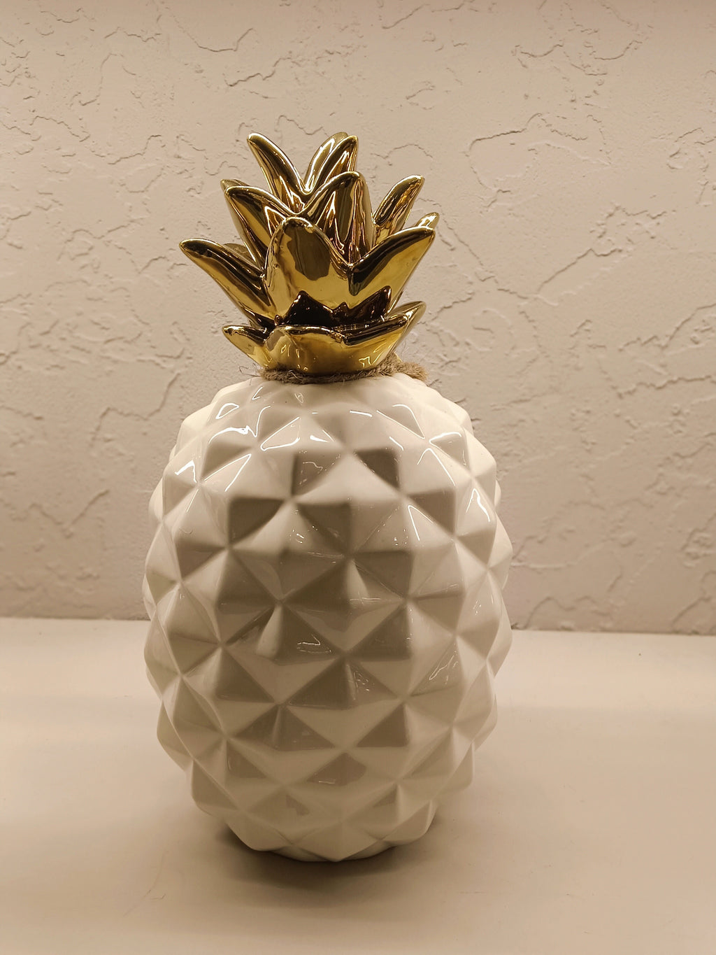 Stylish ceramic pineapple décor pieces with a modern geometric design and glossy finish.