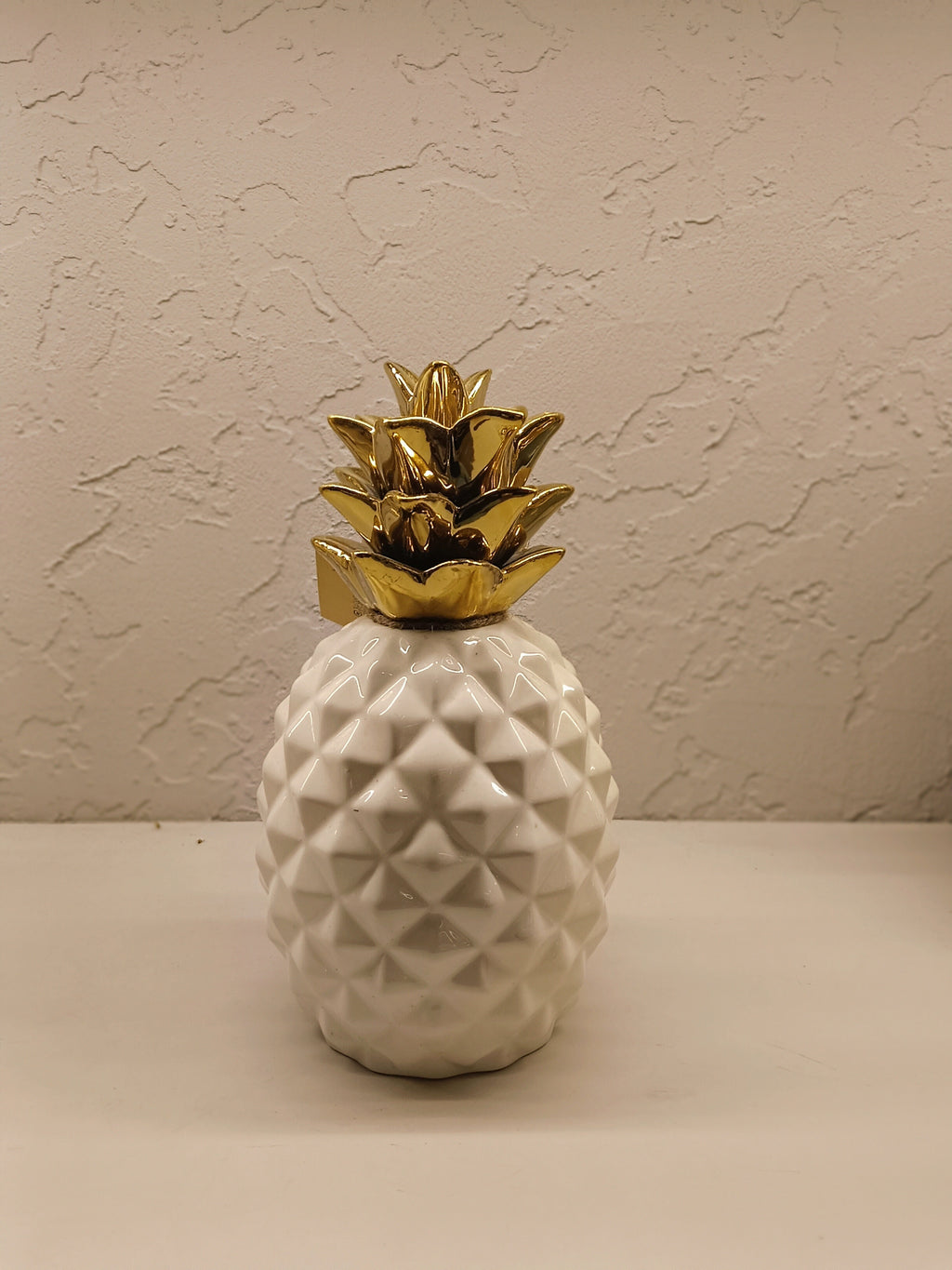 Stylish ceramic pineapple décor pieces with a modern geometric design and glossy finish.