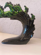 Dynamic and artistic sculpture of running horses, designed with a glossy green and black